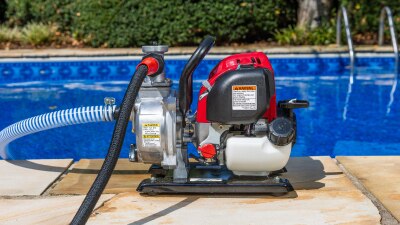 Water pump by the edge of a pool.