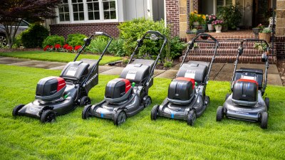 Lineup of battery Lawn Mowers in Garden.