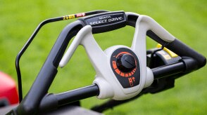 Close up of the battery lawn mower handle showing the Smart Drive label. 