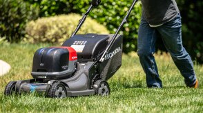 Person using a Honda Battery Lawn Mower to mow the lawn. 