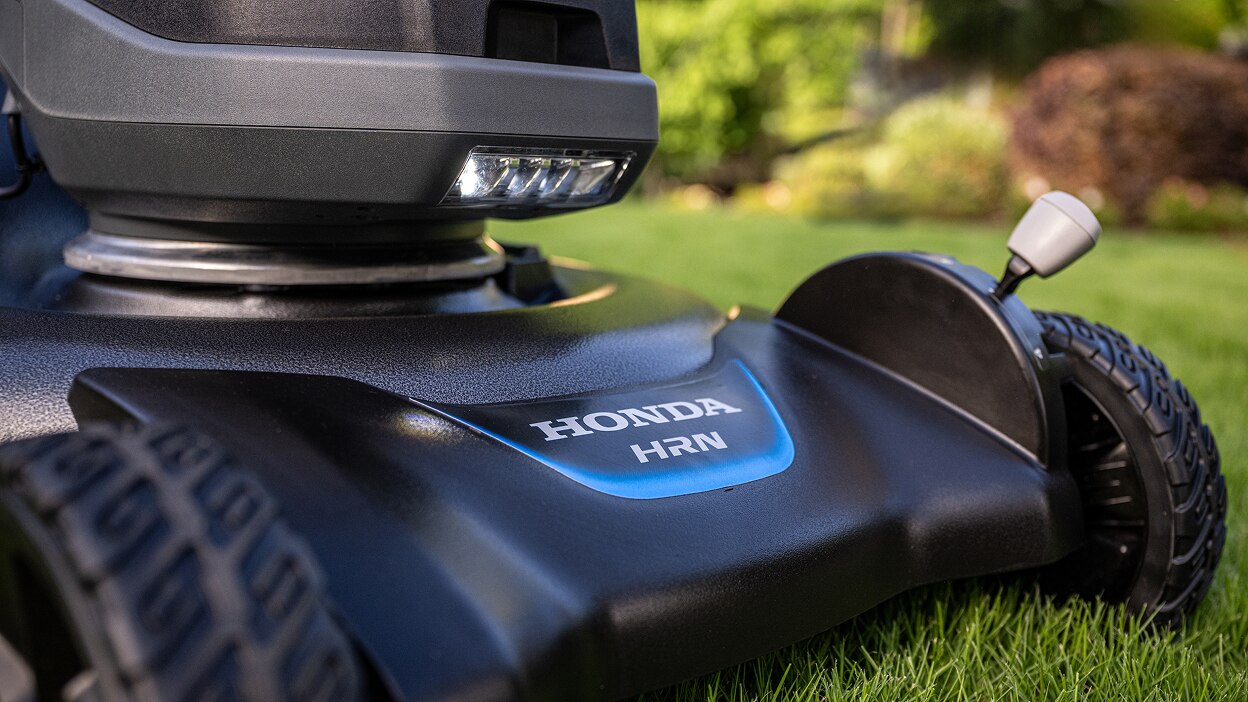Close up of the front of a battery lawn mower showing the label with the model name. 