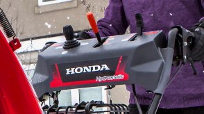 Closeup of the handlebar-mounted control levers on a snowblower.  